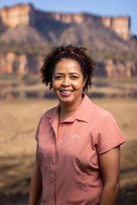 Paula Kahumbu visits the beautiful Gonarezhou National Park, one of the most remote parts of Zimbabwe. The Chilojo Cliffs can be seen in the background, which is why Paula has come. She is here to witness the local elephant herd scale down the cliffs in search of their next water supply in the dry season. (National Geographic for Disney/Freddie Claire)
