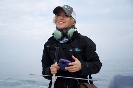 Dr. Megan Winton uses a VHF receiver on the bow of the boat. She tries to get a signal from Liberty's tag. (National Geographic/Brandon Sargeant)