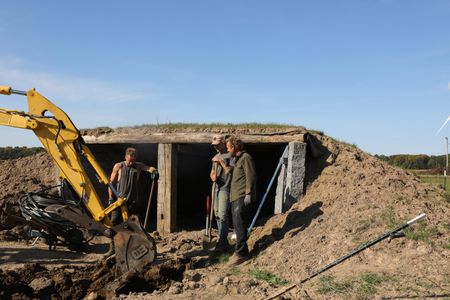Scott Brady, Seth Doble, and Ben Reinhold continue to dig out the sheep hut's floor to add concrete and move the water pipe which will provide better drainage. (National Geographic)