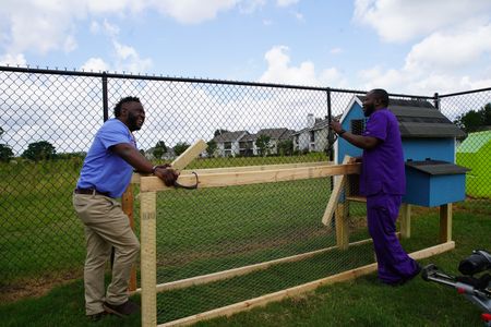 Dr. Hodges and surgery tech Paul build a chicken coop behind the clinic. (National Geographic for Disney/Sean Grevencamp)