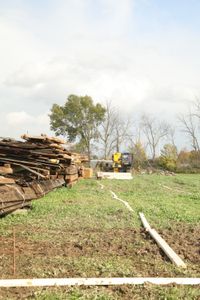 Ben Reinhold operates a telehandler and continues to transport and stack the lumber from the old barn. (National Geographic)