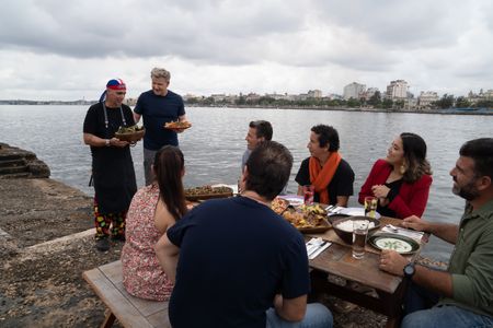 Chef Luis and Gordon Ramsay present their dishes to the guests in Cuba. (National Geographic/Justin Mandel)