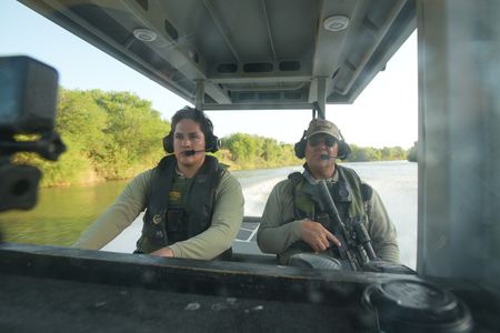 Border Patrol Agents Weeks and Gonzalez are pictured on a boat while looking for signs of illegal migrants in the Rio Grande River in the Rio Grande Valley, Texas. (National Geographic)