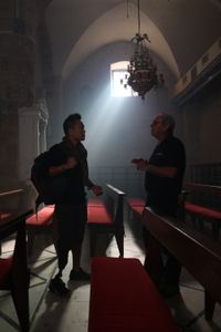 Acre, Israel - Dr. Albert Lin (L) talks to Dr. Eliezer Stern at Saint Andrew's Church, Acre. (Blakeway Productions/National Geographic)