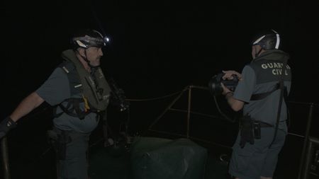 Two guards shine a flashlight in Cadiz, Spain. (National Geographic)