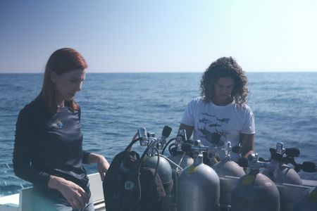 Tanya Houppermans  and Diva Amon checking over diving equipment on Tiger Shark dive boat. (National Geographic/Martin Cass)