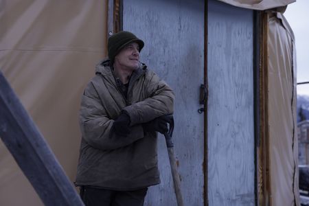 Andy Bassich leans against his yurt while talking to Denise Becker about rabbit snares. (BBC Studios Reality Productions, LLC/Alan Hanna)