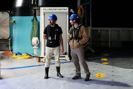 Pedro Afonso and Eric Stackpole on the deck of OceanXplorer. (National Geographic/Mario Tadinac)