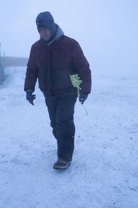 Sue Aikens installs a safety rope to guide her around her camp during a severe winter storm. (BBC Studios Reality Productions, LLC/Jayce Kolinski)