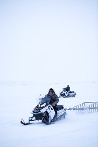 Qutan and Chip Hailstone hunt for caribou while the herd passes through the area. (BBC Studios Reality Productions, LLC/Ashton Hurlburt)