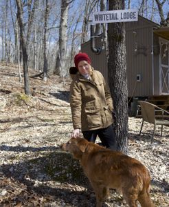 Lori petting her dog outside Whitetail Lodge. (Big Wave Productions)