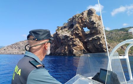 A guard looks at the coast from a patrol boat in Majorca, Balearic Islands, Spain. (National Geographic/Jose Antonio Gavilán Tobal)