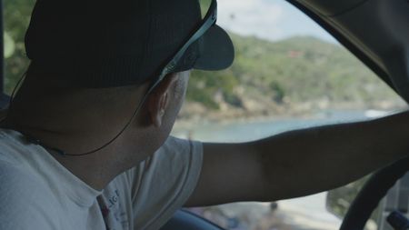 CBP AMO Supervisor Gene looks out over the island as he drives. (Lucky 8 TV/Paul Taggart)