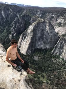 Alex Honnold sits atop the summit of El Capitan. He just became the first person to climb El Capitan without a rope. (National Geographic/Jimmy Chin)
