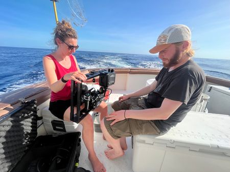 Producer Director Ruth Davies and Camera Operator Jimmy Cape on a boat off the coast of Florida. (National Geographic for Disney/Emily Goldblatt)