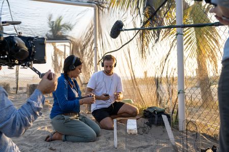 Liz Bonnin and turtle bioacoustics expert Dr. Gabriel Jorgewich-Cohen listen to olive ridley sea turtles vocalizing inside their eggs to synchronize hatching.  (National Geographic/Emilie Ehrhardt)