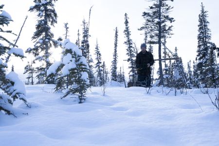 Johnny Rolfe checks his traps while successfully catching a rabbit during the winter season. (BBC Studios Reality Productions, LLC/Tyler Colgan)