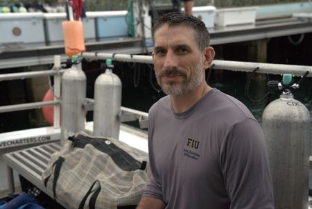 Scientist Dr. Yannis Papastamatiou on the docks at Riviera Beach. (National Geographic/Lisa Tanner)