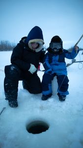 Tinmiaq Hailstone teaches her son Sabastian how to ice fish during the winter. (BBC Studios Reality Productions, LLC/Pedro Delbrey)