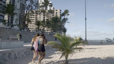Kaylanne Timoteo Freitas and her friend, Emily, walking across Piedade Beach. (National Geographic/Ed Davies)