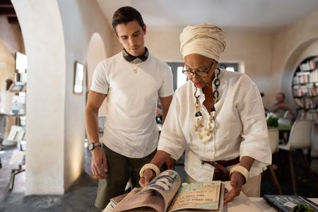 Antoni Porowski and Marie Caroline look through Marie's book collection. (National Geographic/John Wendle)