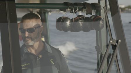 A guard commands a patrol boat in Huelva, Spain. (National Geographic)