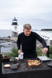 Maine - Gordon Ramsay grilling lobster and corn during the final cook. (Credit: National Geographic/Justin Mandel)