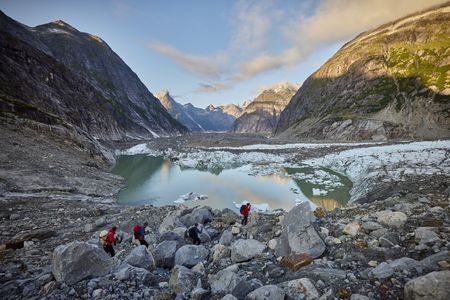 Waldo Etherington, Tommy Caldwell, Taylor Shaffer and Alex Honnold hike past a glacial lake on the approach to the Devil's Thumb.  (National Geographic/Pablo Durana)