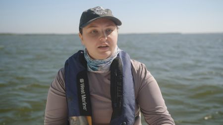 Kristine Zikmanis, expert, explaining the different levels of salinity in the water at Rookery Bay, Fl estuary in comparison to the average salinity levels found in the ocean. (National Geographic)