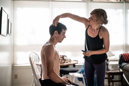Alex Honnold getting his haircut by his girlfriend Sanni McCandless before attempting his free solo of El Cap. (National Geographic/Jimmy Chin)