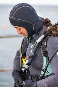 Associate Producer mentee, Raquel Trejo, gearing up to SCUBA dive and scout for octopus in Port Philip Bay.   (photo credit: National Geographic/Harriet Spark)