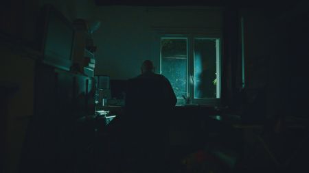 StÈphane Bourgoin is a French author and world-renowned specialist on serial killers, who since 2019 has been at the center of an internet-led controversy spearheaded by a group of anonymous true crime fans.  Here, Bourgoin is seen in silhouette as he works at his desk during the production of "Killer Lies: Chasing a True Crime Con Man," a documentary series about obsession and deception, following the unraveling of Stephane Bourgoinìs career as a best-selling author and serial killer expert. (National Geographic)