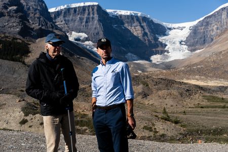 Sir Ranulph Fiennes and actor Joseph Fiennes talk near the Athabasca Glacier as they revisit Ran’s 1971 expedition of Canada’s British Columbia.  Amidst mountains and whale watching, Sir Ranulph Fiennes and his cousin Joseph Fiennes reflect on Ran’s epic life and his new challenge of life with Parkinson’s. (National Geographic)