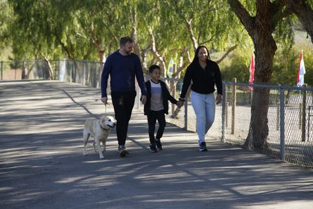 Derek and Ashley walk up to the Dog Psychology Center with dog Sansa and their son Phoenix. (National Geographic)