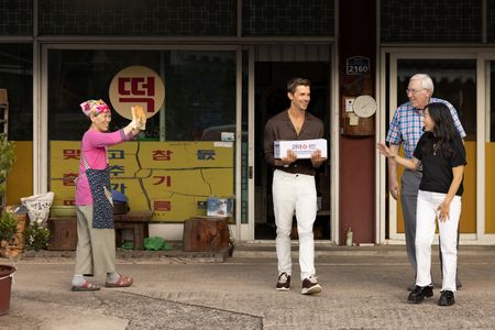 Yoon Hee Lee waves goodbye to Antoni Porowski, Mark Peterson, and Awkwafina after showing them how to make tteok. (Credit: National Geographic/Seong Joon Cho)