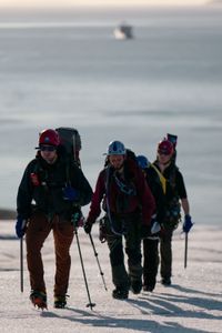 PolarX guide Loup Supery, Andreas Alexander, Melissa Marquez, and PolarX guide Tom Lawton snow hiking up hill. (National Geographic/Mario Tadinac)