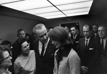 Aboard Air Force One, Lyndon B. Johnson speaks with former first lady Jacqueline Kennedy during the ceremony where he was sworn in as President of the United States, Nov. 22, 1963, in Dallas. (Cecil Stoughton/White House Photographs/John F. Kennedy Presidential Library and Museum, Boston)