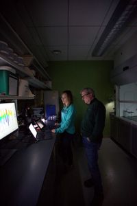 Dr. Megan Winton and Dr. Greg Skomal, stand looking at the analysis of the data retrieved from Liberty's tag in a lab at the School for Marine Science and Technology in New Bedford, MA. (National Geographic/Zara Tyne)