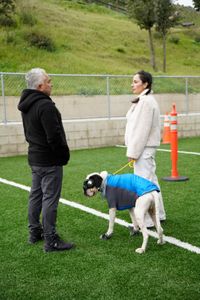 Cesar talks with Adriana as she holds her dog Brunello on leash. (National Geographic)