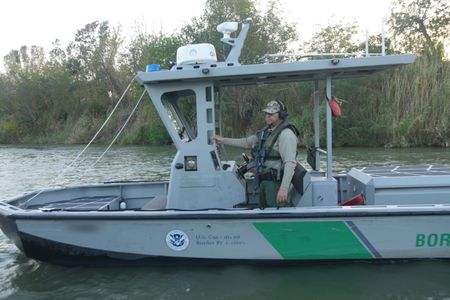 Border Patrol Agents Weeks and Gonzalez are pictured on a boat while looking for signs of illegal migrants in the Rio Grande River in the Rio Grande Valley, Texas. (National Geographic)