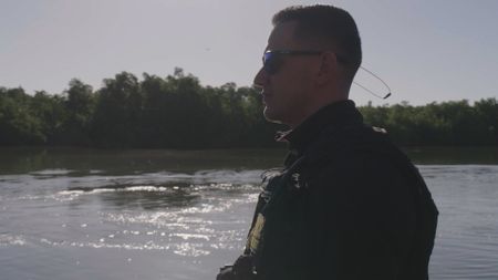 CBP AMO Agent Yadier scans the water for suspicous activity near Mayaguez, P.R. (Lucky 8 TV/Paul Taggart)