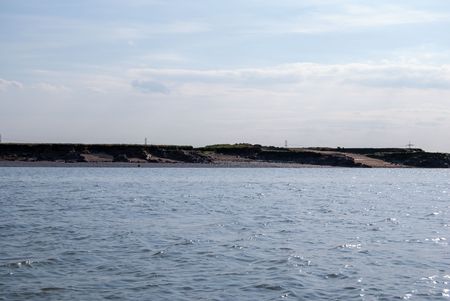 Situated in the estuary of the River Medway in Kent, United Kingdom is a tiny islet named Deadman’s Island. Though the island is now an off-limit nature paradise for birds nesting and breeding, visitors arriving at this wildlife preserve are greeted with a macabre scene: the muddy marshland is strewn with human skulls, teeth, and exposed coffins. (Credit: Adam Chodzko)