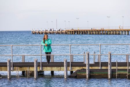Storyteller and cephalopod expert, Dr Alex Schnell on a pier in Port Phillip Bay.  (photo credit: National Geographic/Harriet Spark)