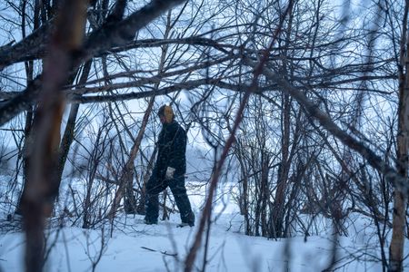 Chevie Roach gathers branches to build a blind during the migratory water fowl hunting season. (BBC Studios Reality Productions/Jayce Kolinski)