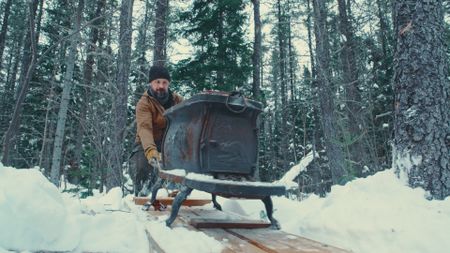 Billy struggles to push a family heirloom - a cast-iron stove - through the snow. (Blue Ant Media/Tara Elwood)