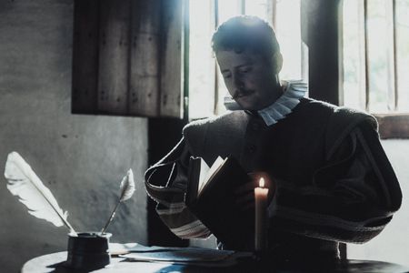 David Seton is standing over a pile of letters as he opens a book. (Dash Productions Services LTD/Antoan Ivanov)