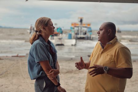 Mariana van Zeller (L) interviews the owner of a boating company that shuttles migrants from Necoclì, Colombia to the Darién Gap. (Credit: National Geographic)