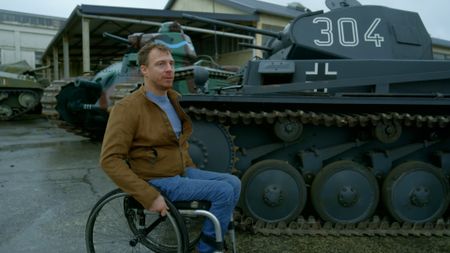 Arthur Williams is pictured near a German Panzer 2 Tank and French Char B1 tank. (National Geographic)