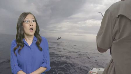 Comedian Helen Hong reacts to a shark jumping out of the water in front of fisherman's boat. (National Geographic)