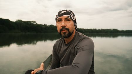 National Geographic Explorer Fernando Trujillo watches for pink dolphins or Toninas at dawn in Laguna Damas de Nare. (credit: National Geographic/Jorge Panchoaga)